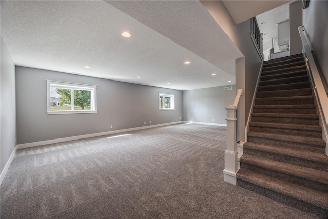 below grade area featuring stairway, carpet floors, recessed lighting, and baseboards