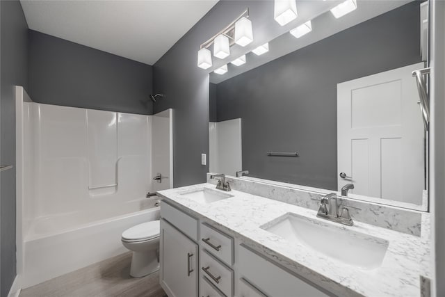 full bathroom featuring toilet, hardwood / wood-style flooring, shower / tub combination, and vanity