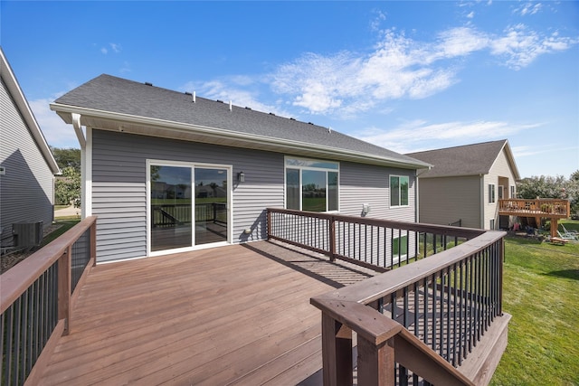 wooden terrace with a lawn