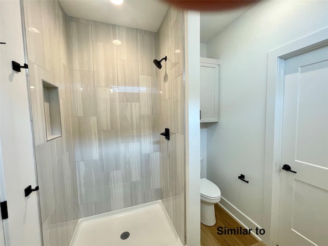 bathroom with a shower, wood-type flooring, and toilet