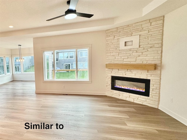 unfurnished living room with ceiling fan, hardwood / wood-style flooring, and a fireplace