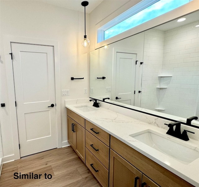 bathroom featuring a shower, wood-type flooring, and vanity