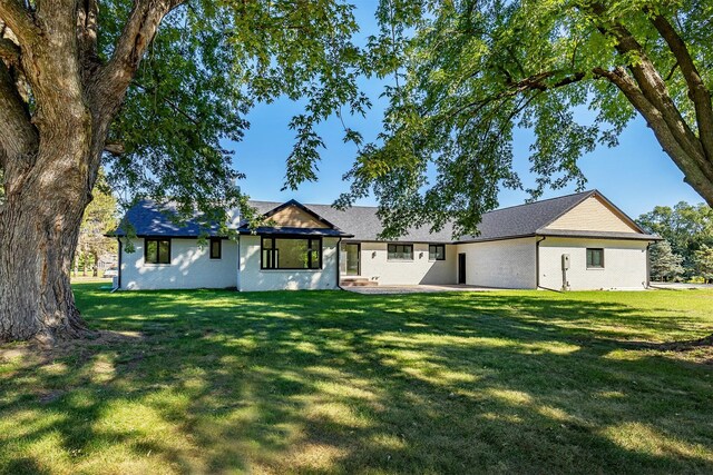 view of front of property with a patio and a front yard