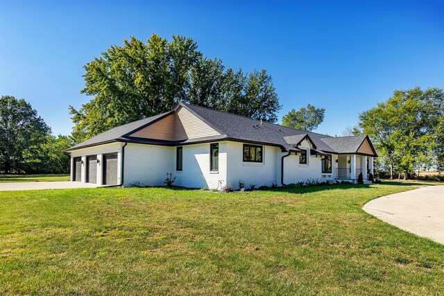 view of front facade with a front yard and a garage