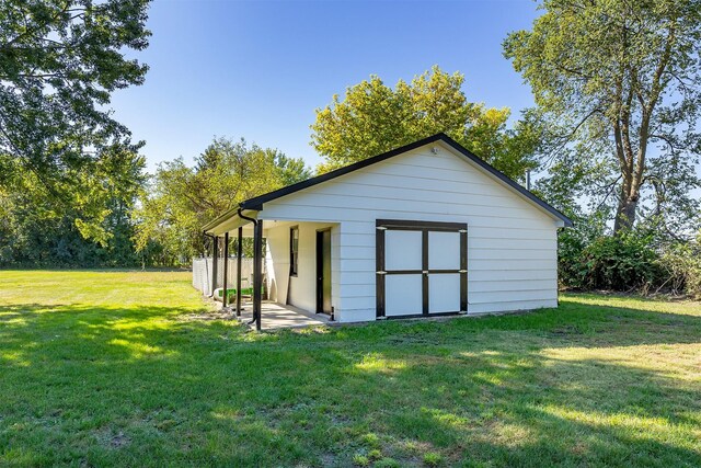 view of outdoor structure with a lawn