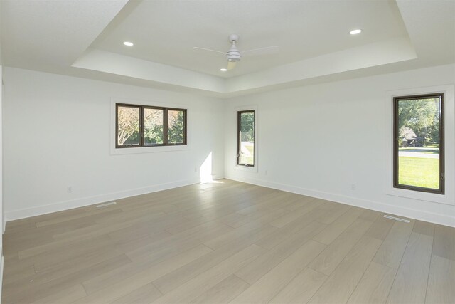 10318 NW 106th Ave, Granger, IA 50109 - spare room with ceiling fan, a healthy amount of sunlight, and a tray ceiling