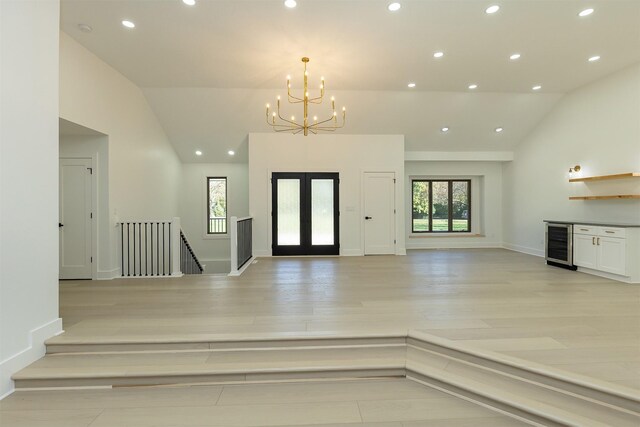 10318 NW 106th Ave, Granger, IA 50109 - entryway with vaulted ceiling, wine cooler, plenty of natural light, and a notable chandelier
