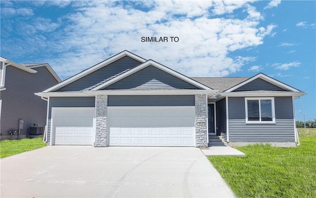 view of front of house with cooling unit, a garage, and a front yard