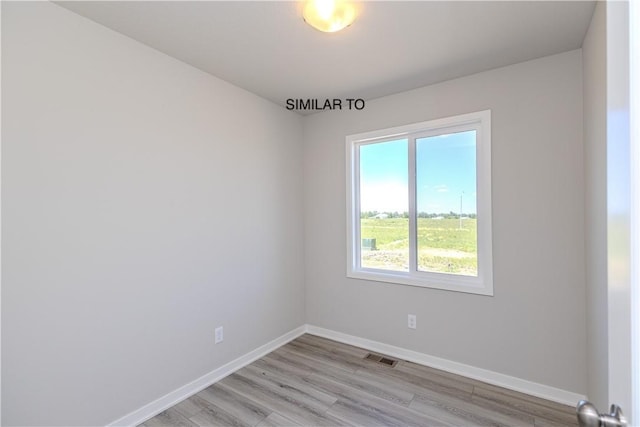 spare room featuring light hardwood / wood-style flooring