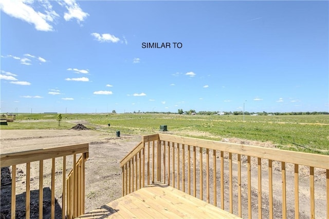 wooden deck with a rural view