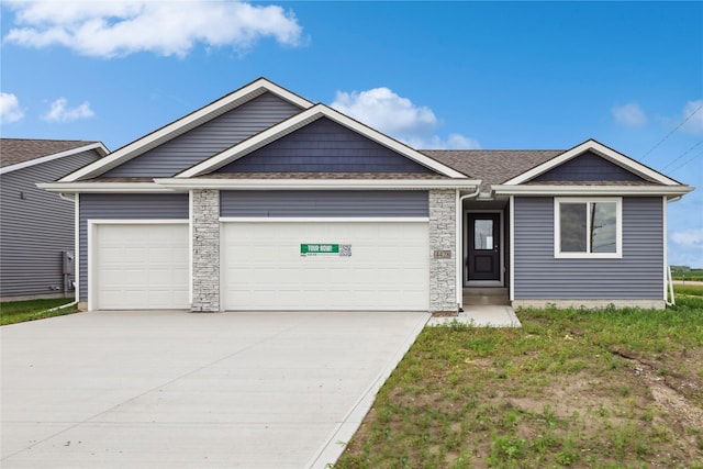 4428 NE 8th St, Ankeny, IA 50021 - view of front of home with an attached garage, concrete driveway, and stone siding