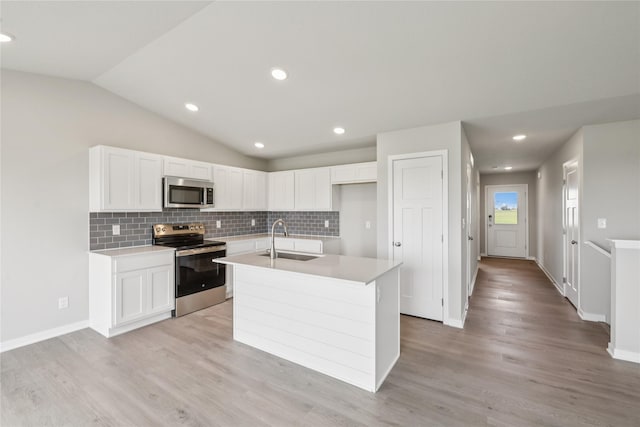 4428 NE 8th St, Ankeny, IA 50021 - kitchen featuring stainless steel appliances, a sink, white cabinets, a center island with sink, and backsplash