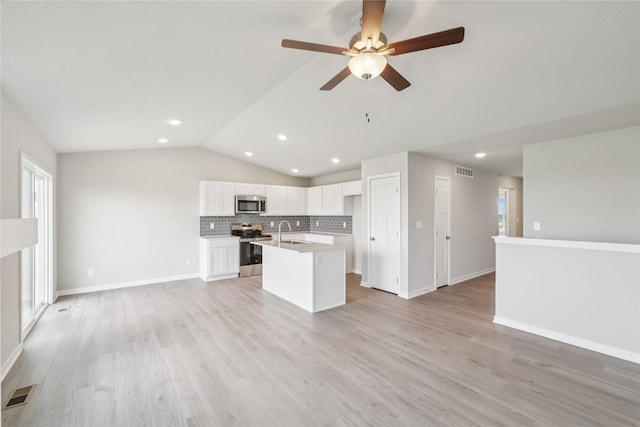 4428 NE 8th St, Ankeny, IA 50021 - kitchen with appliances with stainless steel finishes, open floor plan, a sink, lofted ceiling, and backsplash