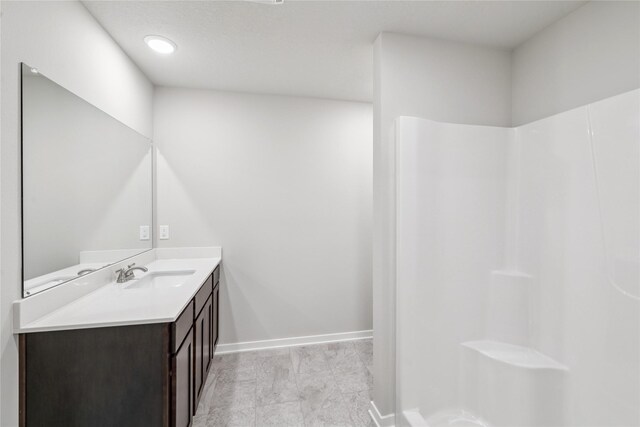 4428 NE 8th St, Ankeny, IA 50021 - full bath with vanity, a shower, and baseboards