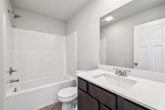 4428 NE 8th St, Ankeny, IA 50021 - full bathroom featuring toilet, vanity, wood finished floors, and shower / bath combination