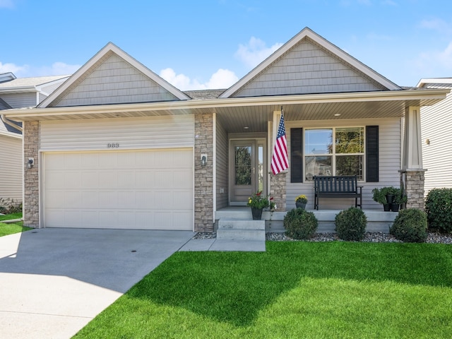 view of front of house with a porch, a garage, and a front yard