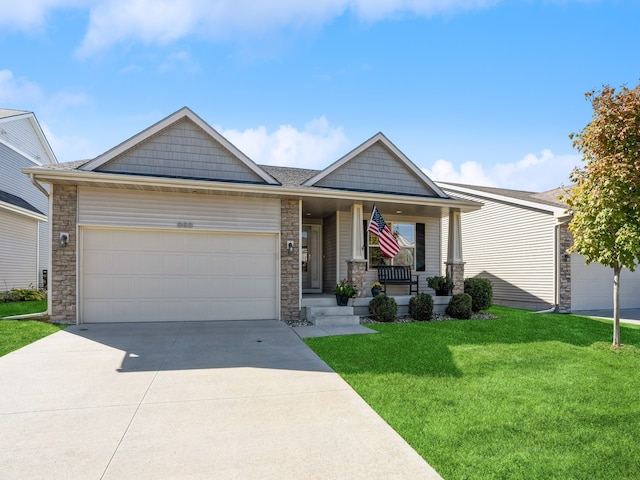 view of front facade featuring a front lawn, a porch, and a garage