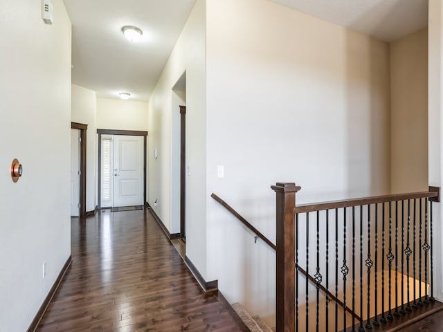 hallway featuring a textured ceiling and dark wood-type flooring