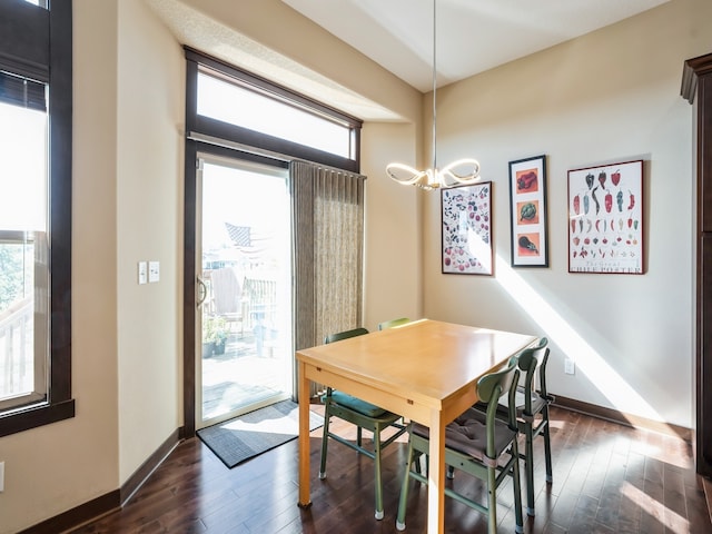 dining space featuring a notable chandelier and dark hardwood / wood-style flooring