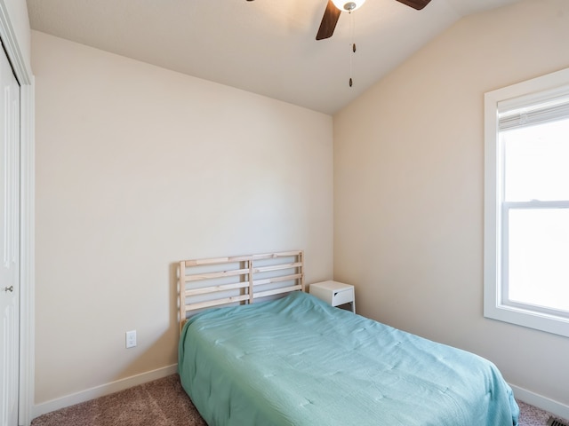 bedroom with ceiling fan, carpet flooring, a closet, and vaulted ceiling