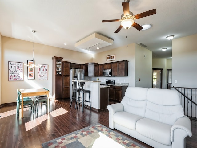 living room with ceiling fan and dark hardwood / wood-style floors