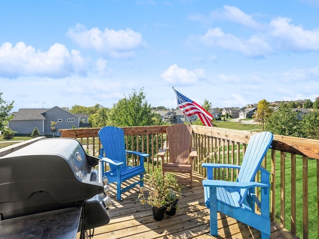 deck featuring area for grilling and a yard