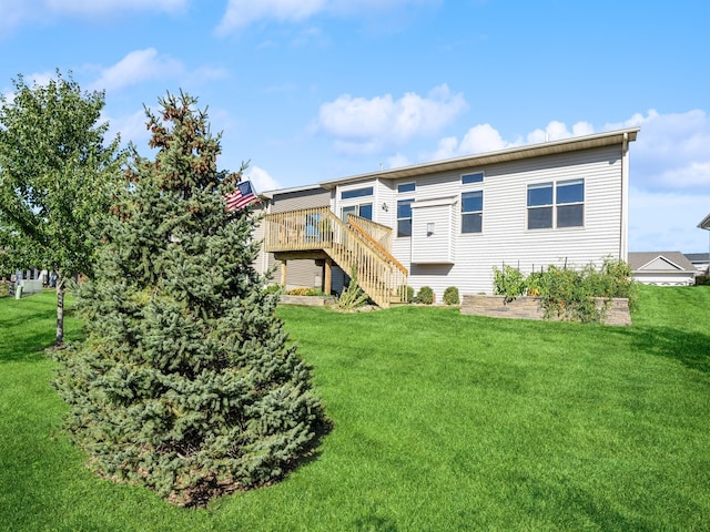 back of property with a yard and a wooden deck