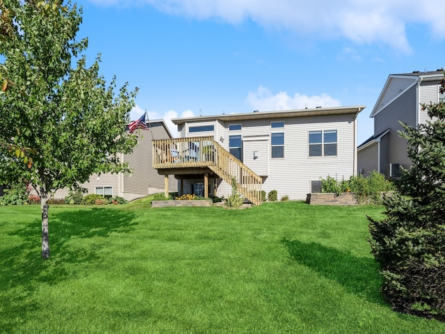 rear view of house with central AC unit, a wooden deck, and a yard