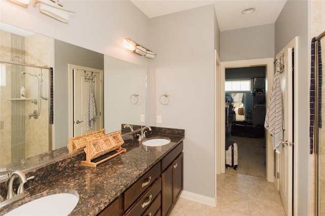 bathroom featuring tile patterned flooring, walk in shower, and vanity