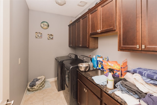 laundry area featuring cabinets, independent washer and dryer, and light tile patterned floors