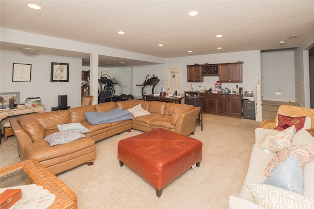 carpeted living room featuring bar area and a textured ceiling