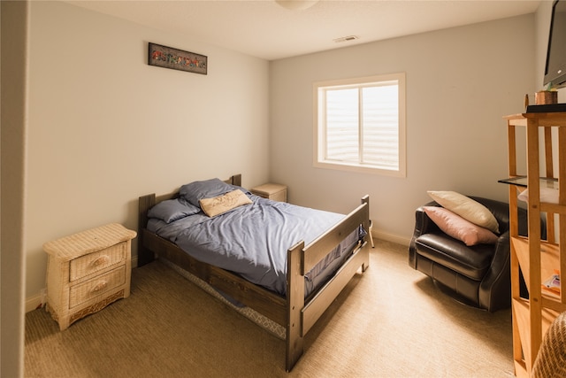 bedroom featuring light carpet