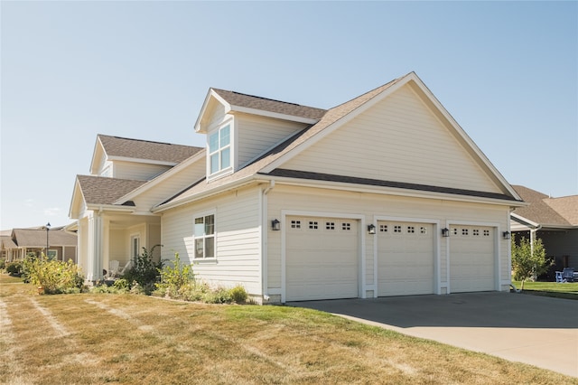 view of side of home with a garage and a yard