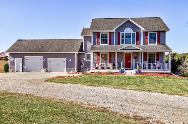 colonial home featuring a front yard, a garage, and covered porch