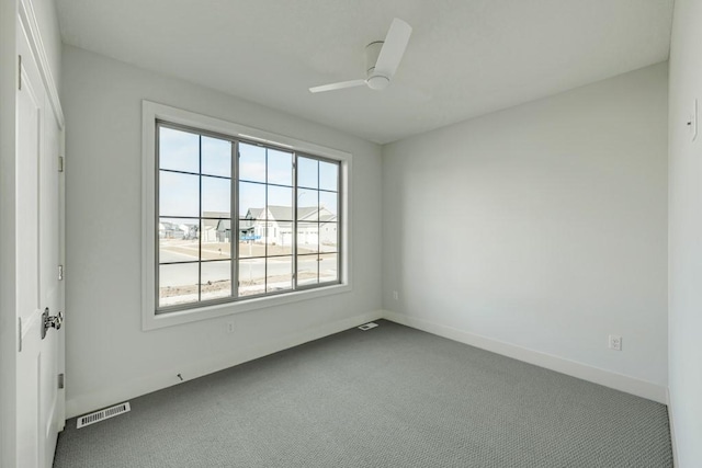 spare room with ceiling fan and carpet flooring