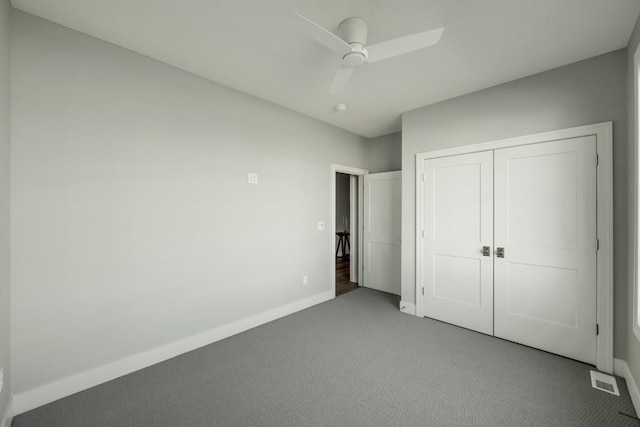 unfurnished bedroom featuring ceiling fan, a closet, and carpet flooring