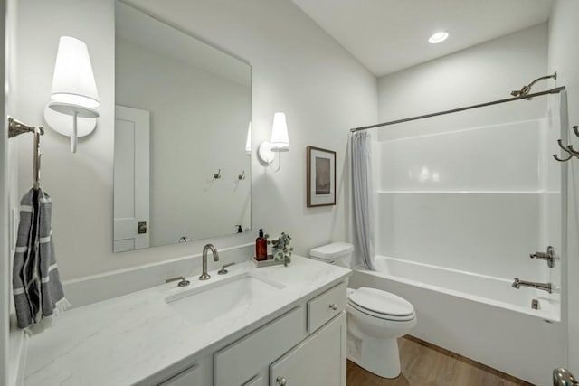 full bathroom with hardwood / wood-style floors, toilet, vanity, and shower / tub combo with curtain