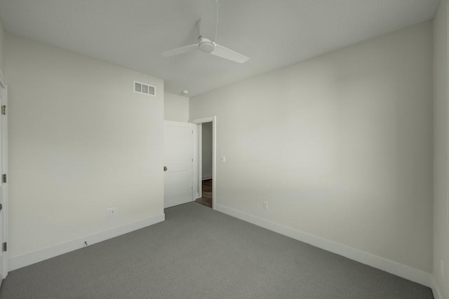 unfurnished bedroom with ceiling fan and dark colored carpet