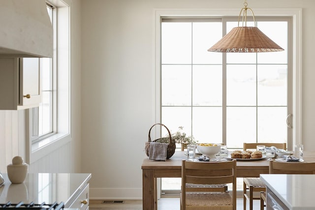 office area featuring wood finished floors, visible vents, and baseboards