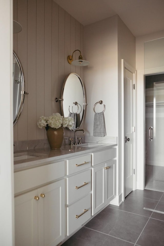 bathroom featuring tile patterned flooring, a sink, and double vanity