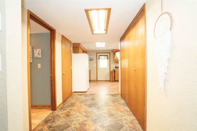 hallway with light hardwood / wood-style floors