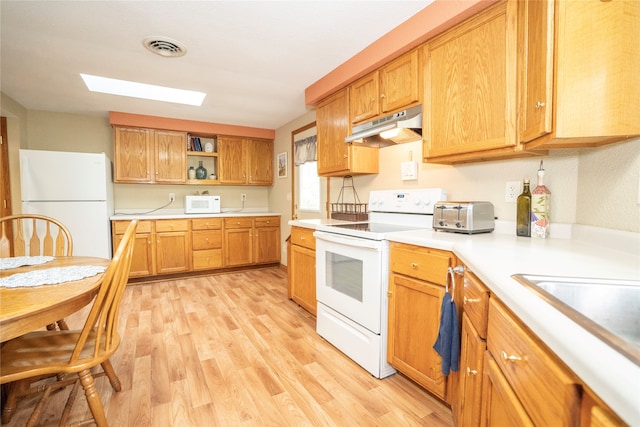 kitchen featuring light wood-type flooring and white appliances