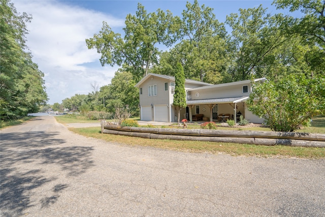 view of property featuring a garage and covered porch