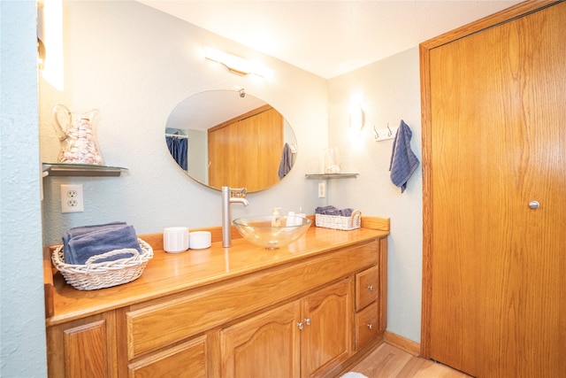 bathroom with vanity and hardwood / wood-style flooring