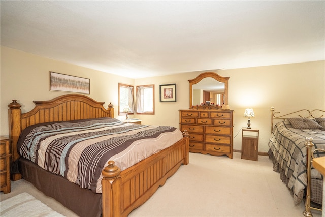 bedroom featuring light carpet