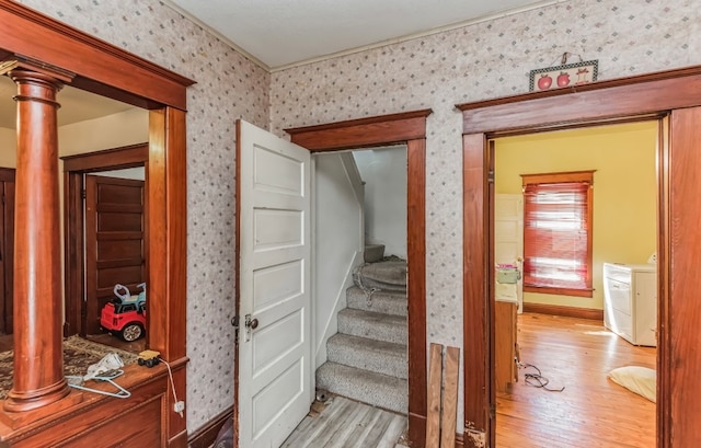 stairway featuring washer / clothes dryer and hardwood / wood-style flooring