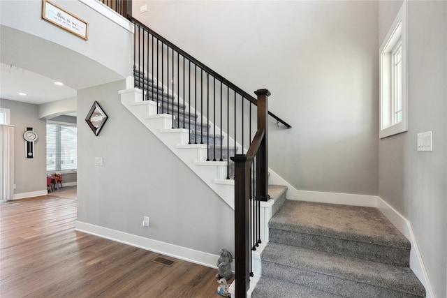 staircase with hardwood / wood-style floors