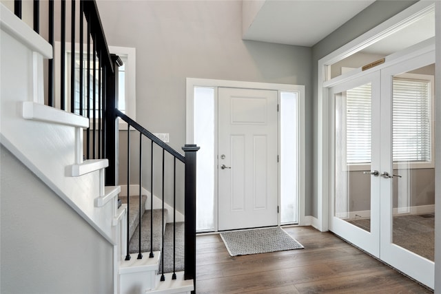 foyer entrance featuring dark hardwood / wood-style floors and french doors