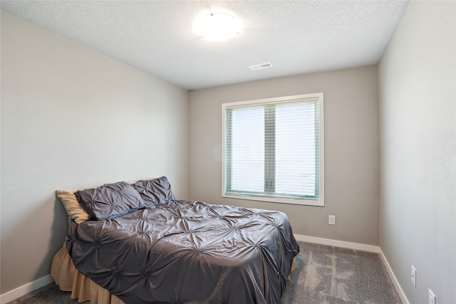 carpeted bedroom with a textured ceiling