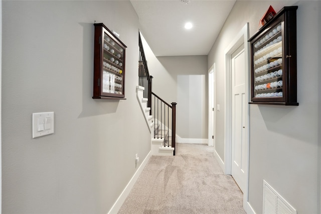 hallway with light colored carpet